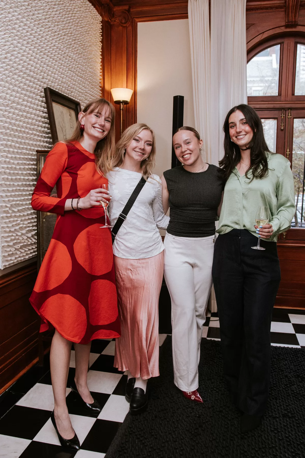 Four guests posing together at a company event