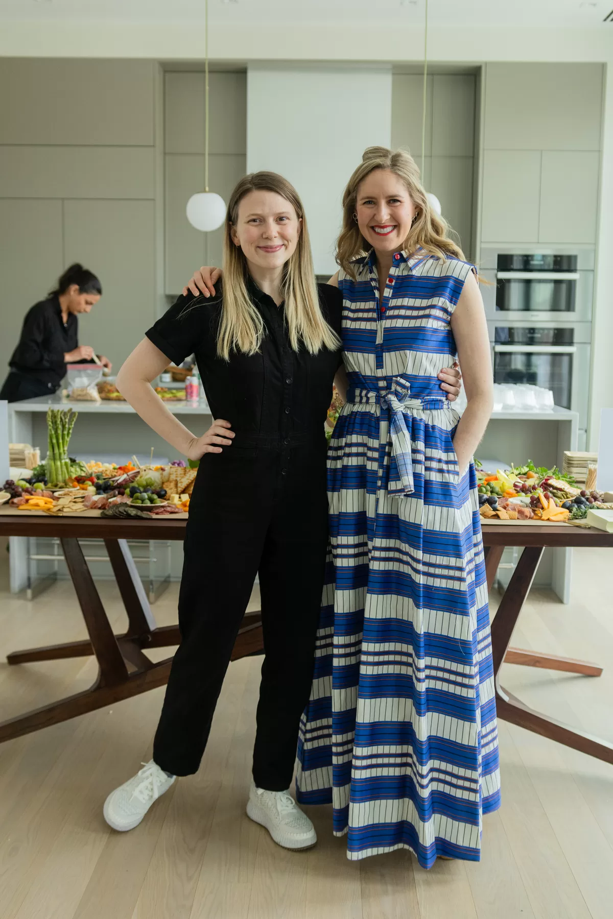 Book launch hosts posing in a bright event space