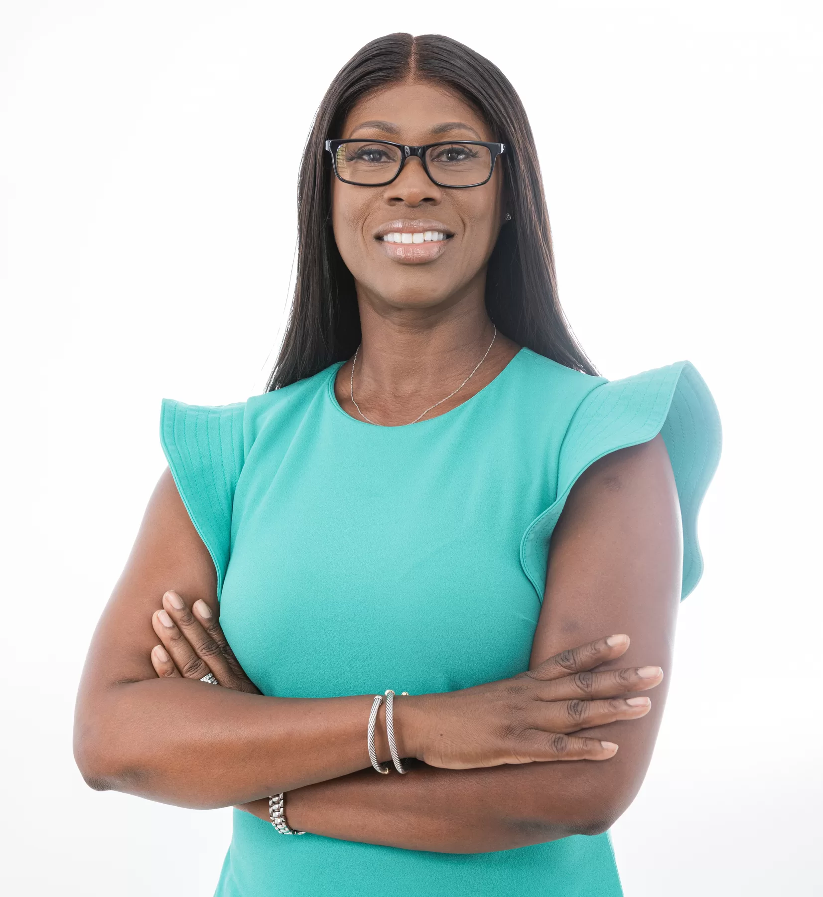 Corporate female headshot in a teal dress