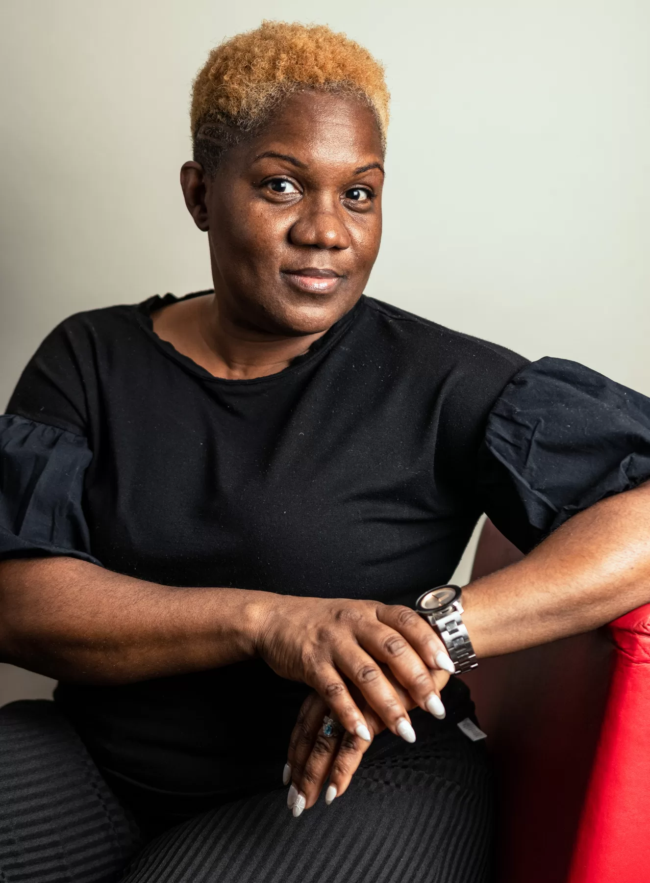 Editorial female headshot seated against a neutral background