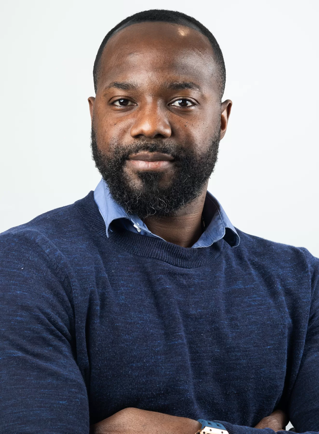 Professional male headshot in a blue sweater