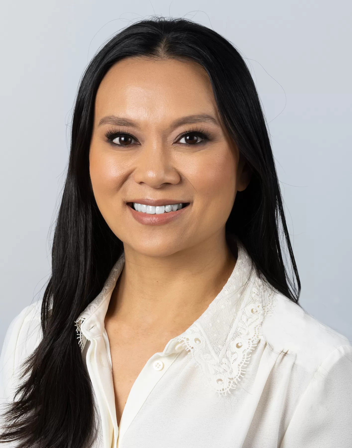 Professional female headshot in a white blouse