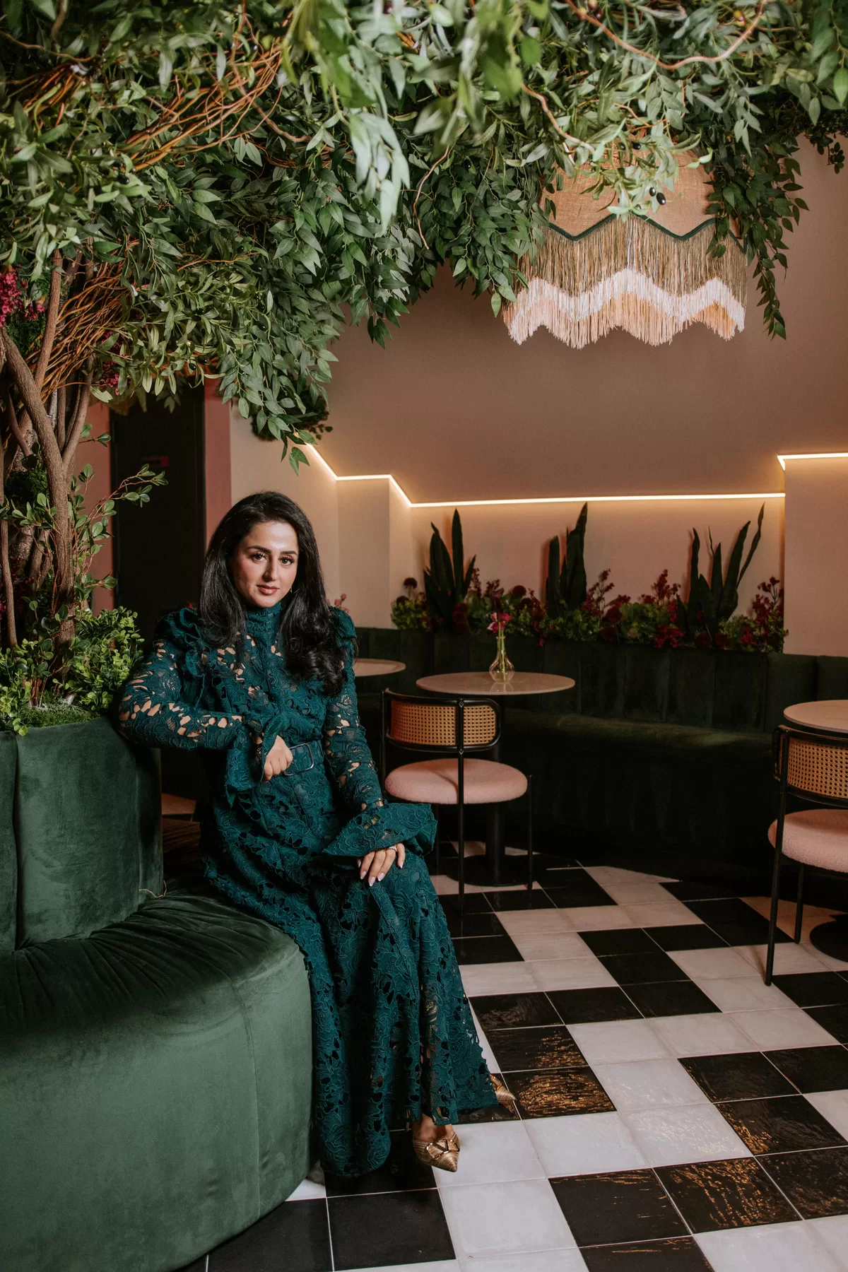 Woman seated in a richly styled lounge for an environmental portrait