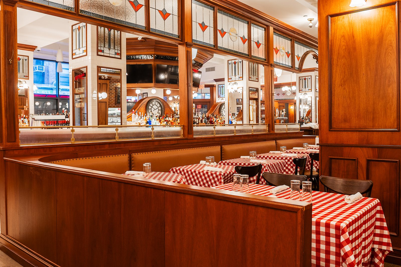 PJ Clarke's 34th Street bar with stained glass and mirrors, the street outside still visible through the window