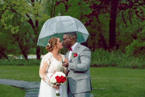 Newlyweds sharing a moment under an umbrella
