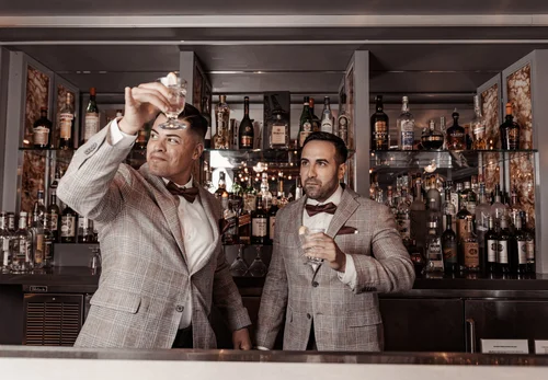 Wedding guests raising their glasses during a reception toast