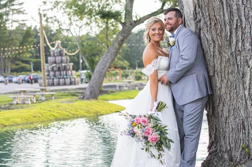 Newlyweds walking together after a waterfront ceremony