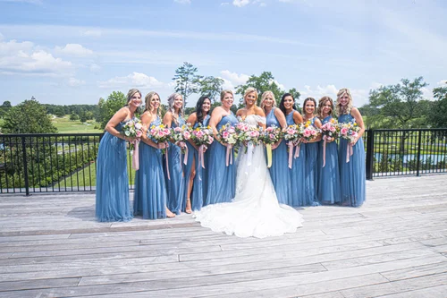 Wedding party gathered outdoors with the couple