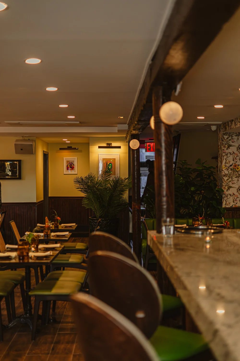 Mango Bay dining room and marble bar photographed in warm evening light before service